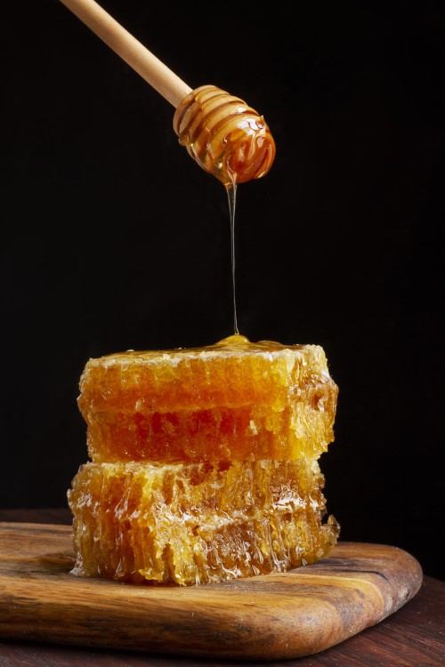 front-view-honey-dipper-dripping-honey-honeycomb.jpg
